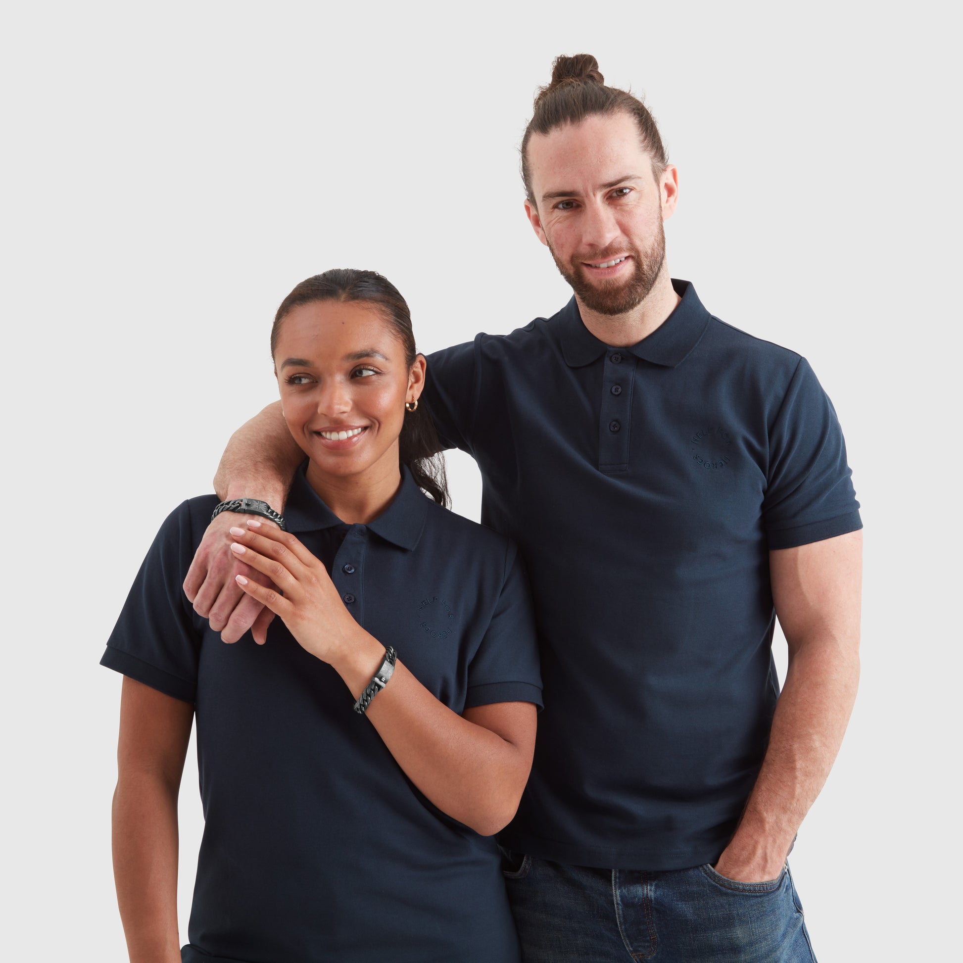 Two models wearing gunmetal curb chain bracelets with a clasp featuring the Union Jack and Help for Heroes logo