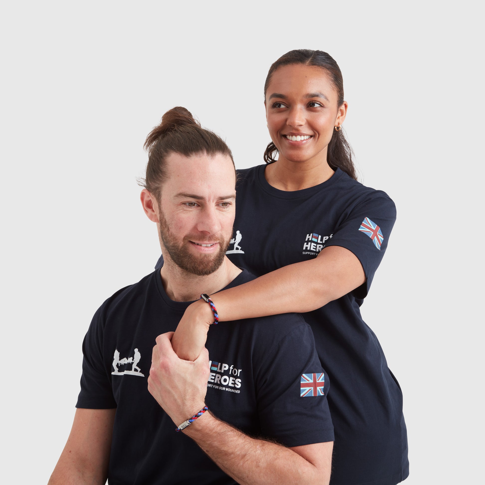 Two models wearing tri-coloured leather ID bar bracelets, with a metal clasp featuring the Help for Heroes logo
