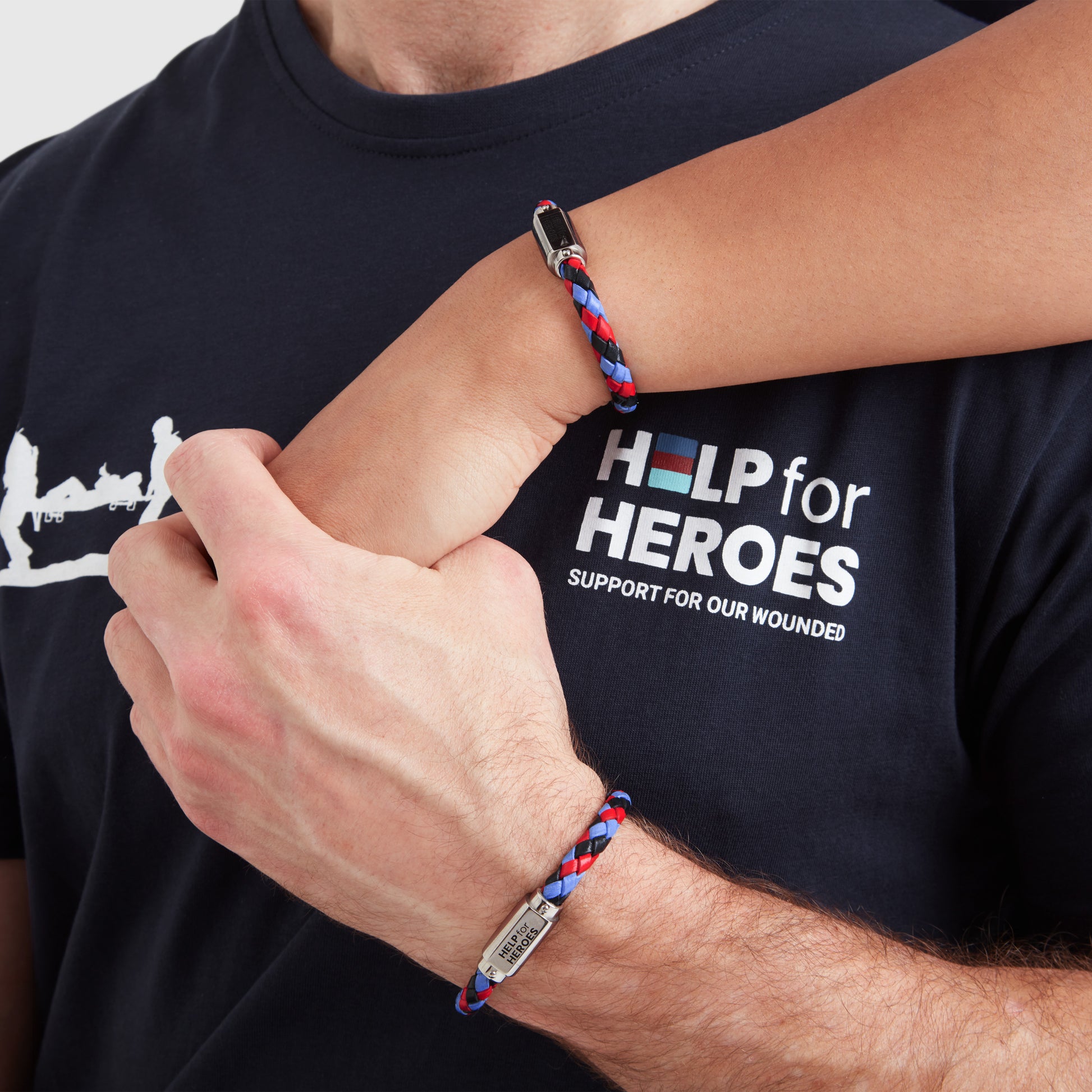 A model wearing a tri-coloured leather ID bar bracelet, with a metal clasp featuring the Help for Heroes logo