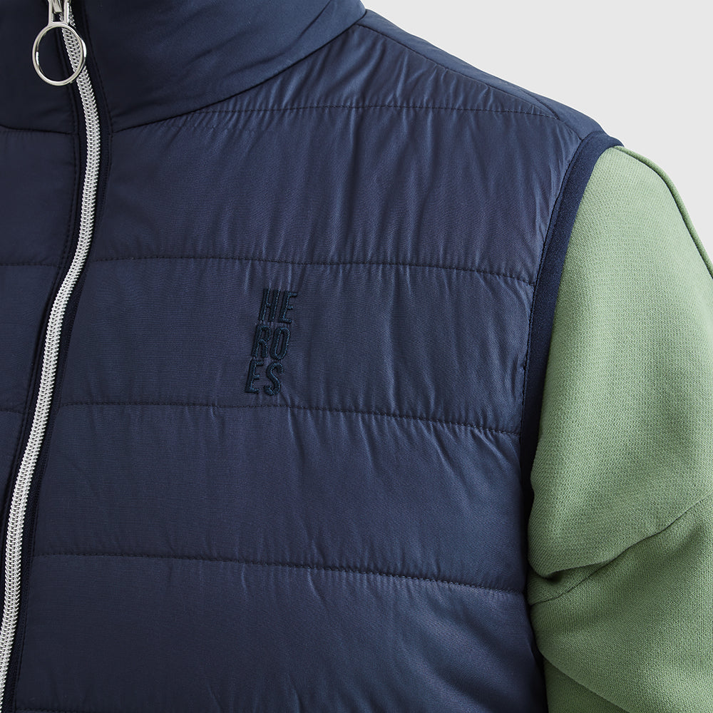 Close up image of embroidered Help for Heroes logo on the chest of padded gilet in navy