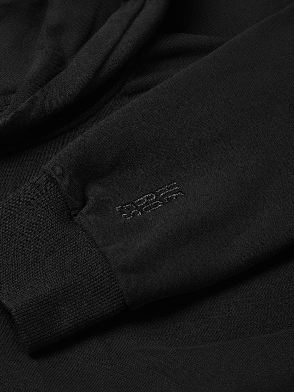 Close up image of embroidered Help for Heroes stacked logo on the sleeve of pullover black hoodie