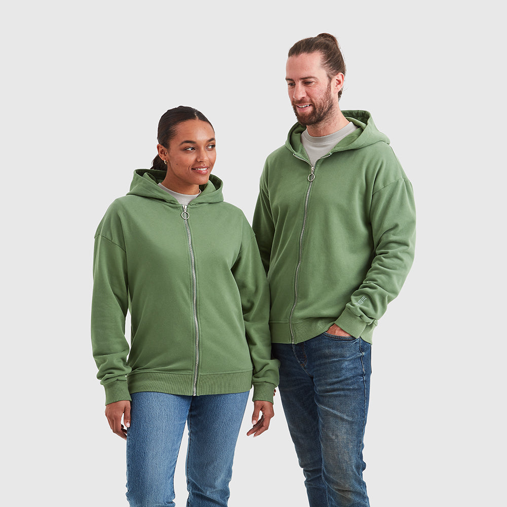 Two models wearing relaxed fit, zipped Help for Heroes hoodies in washed green. Featuring embroidered Heroes logo on the sleeve