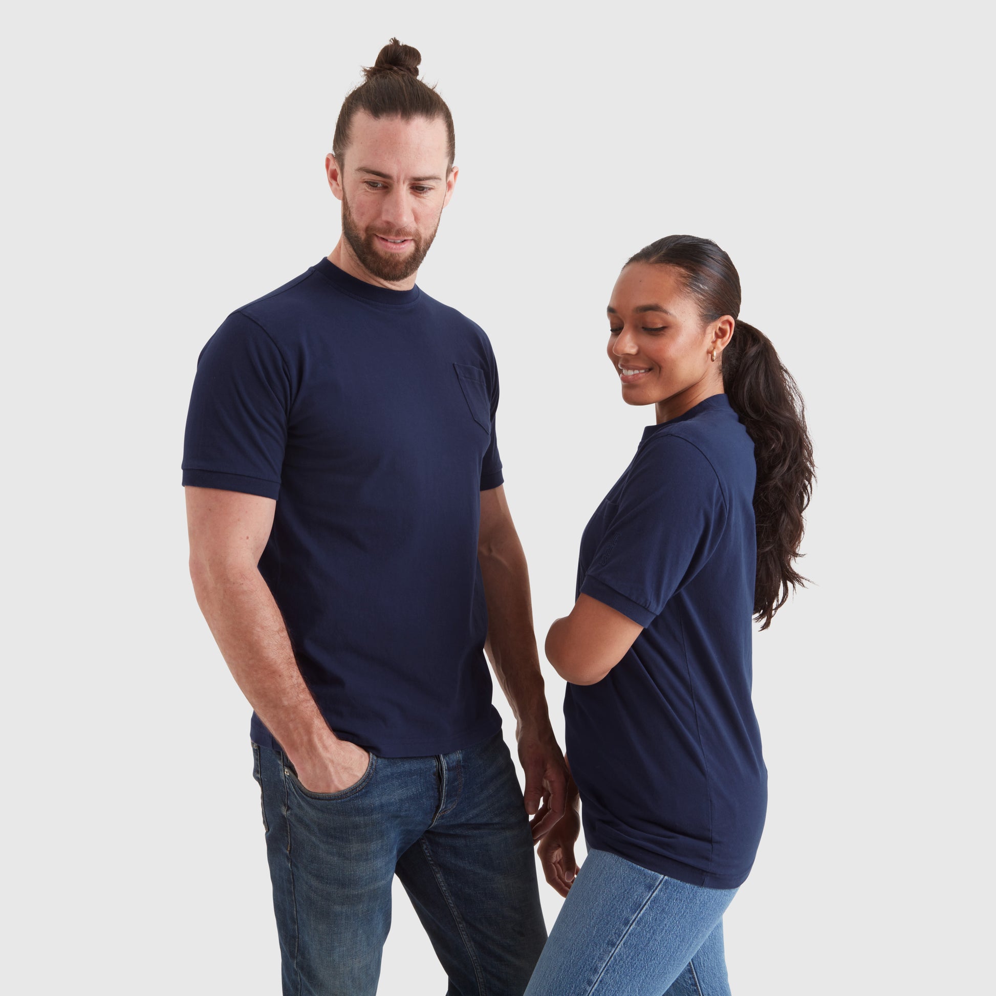 Two models wearing washed navy blue t-shirts with a chest pocket and a subtle Help for Heroes embroidered logo on the sleeve