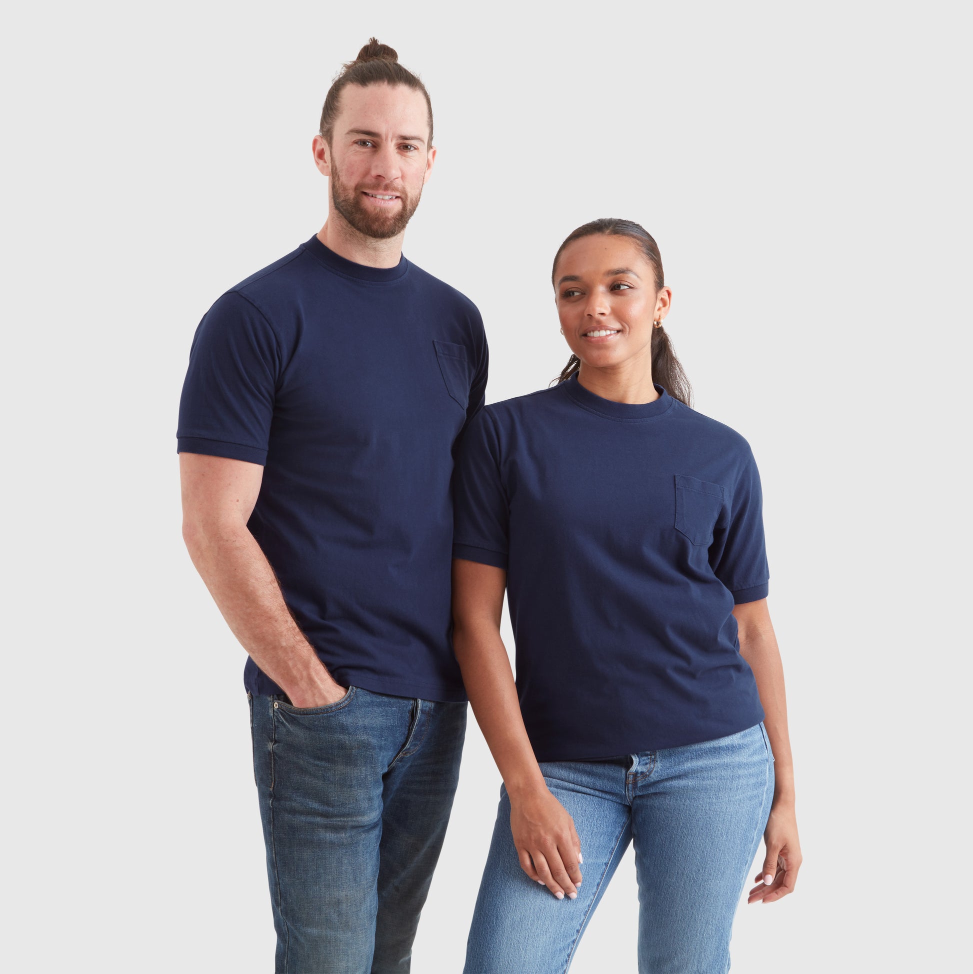 Two models wearing washed navy blue t-shirts with a chest pocket and a subtle Help for Heroes embroidered logo on the sleeve