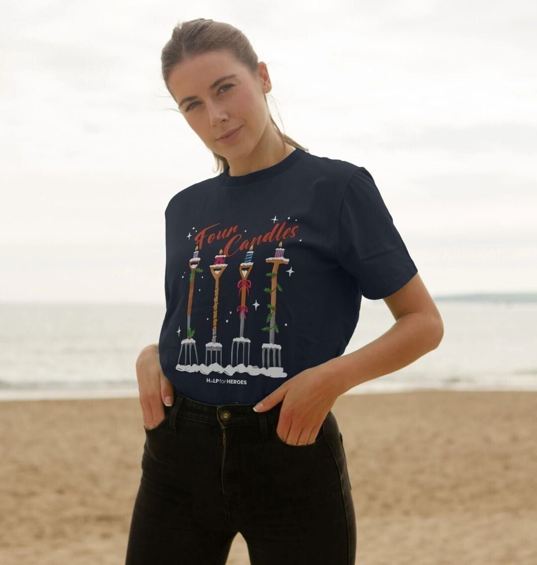 Female model wearing navy Help for Heroes Christmas tshirt, featuring the Four Candles graphic print