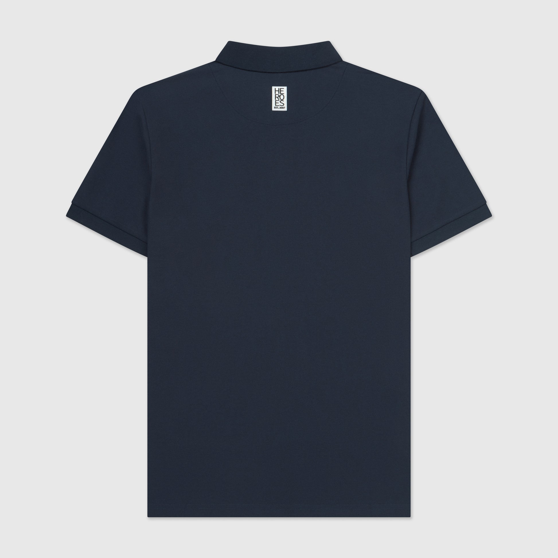 Back image of navy pique polo shirt with a subtle circular Help for Heroes logo on the chest and a rubber Heroes stack patch at the back neck.