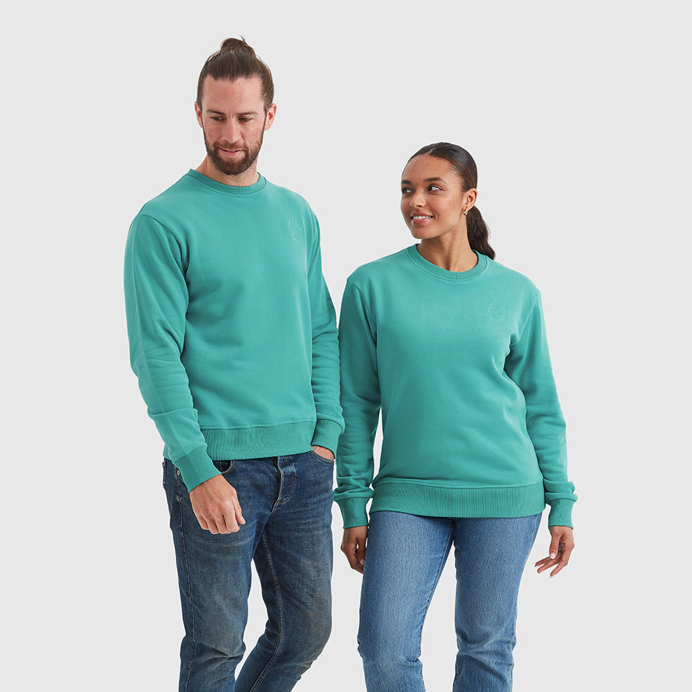 Two models wearing crew neck Help for Heroes sweatshirts in turquoise, featuring an embroidered circular Help for Heroes logo on the chest and a rubber Heroes rubber logo on the back neck