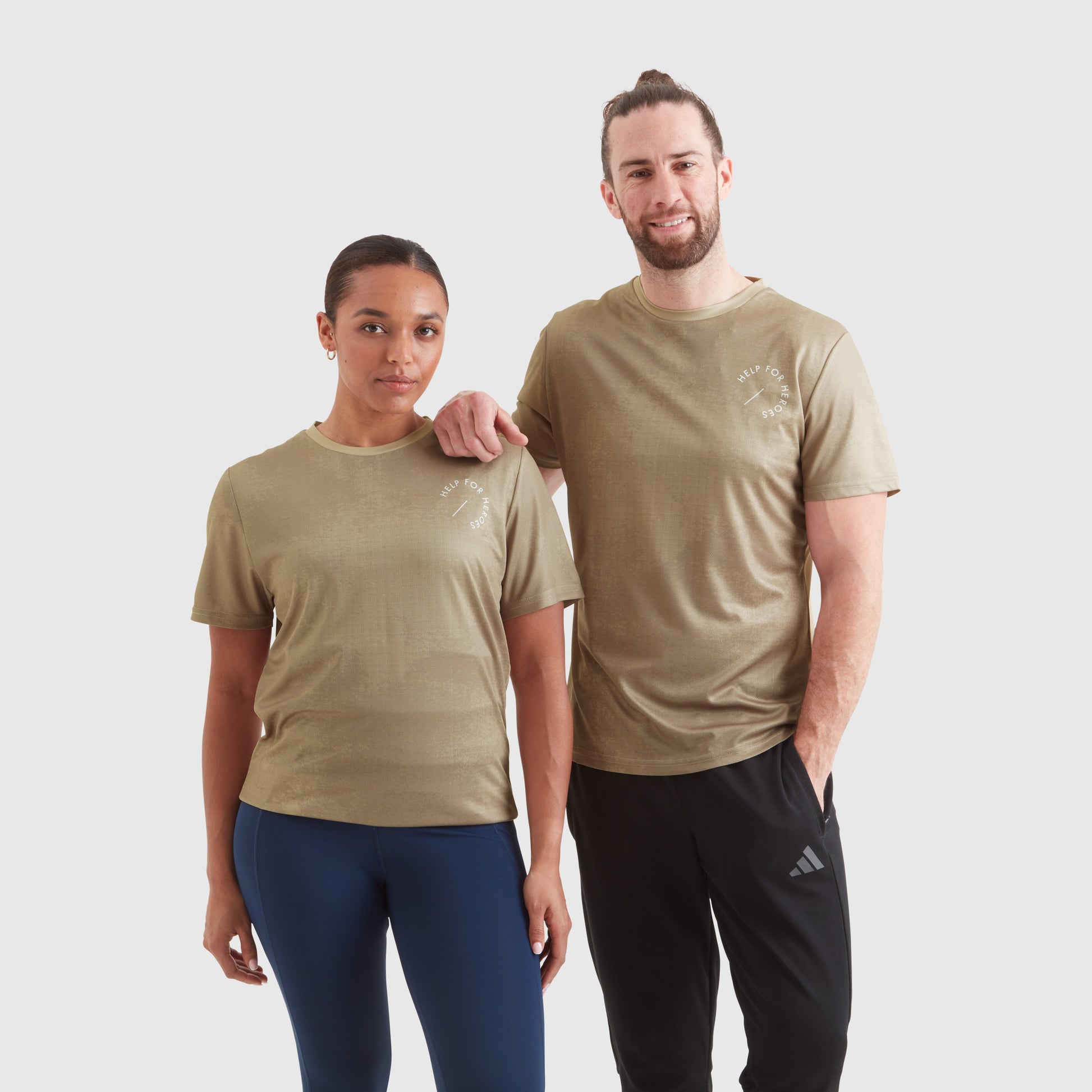 Two models wearing a taupe ombre sport leisure t-shirt, with a circular Help for Heroes logo on the chest