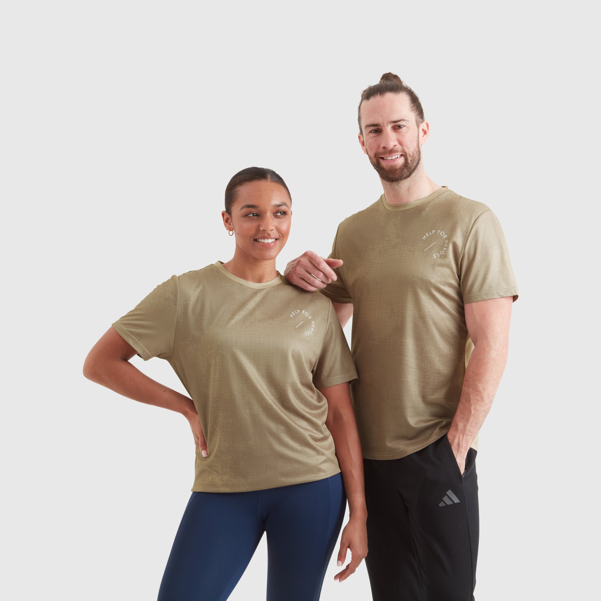 Two models wearing a taupe ombre sport leisure t-shirt, with a circular Help for Heroes logo on the chest