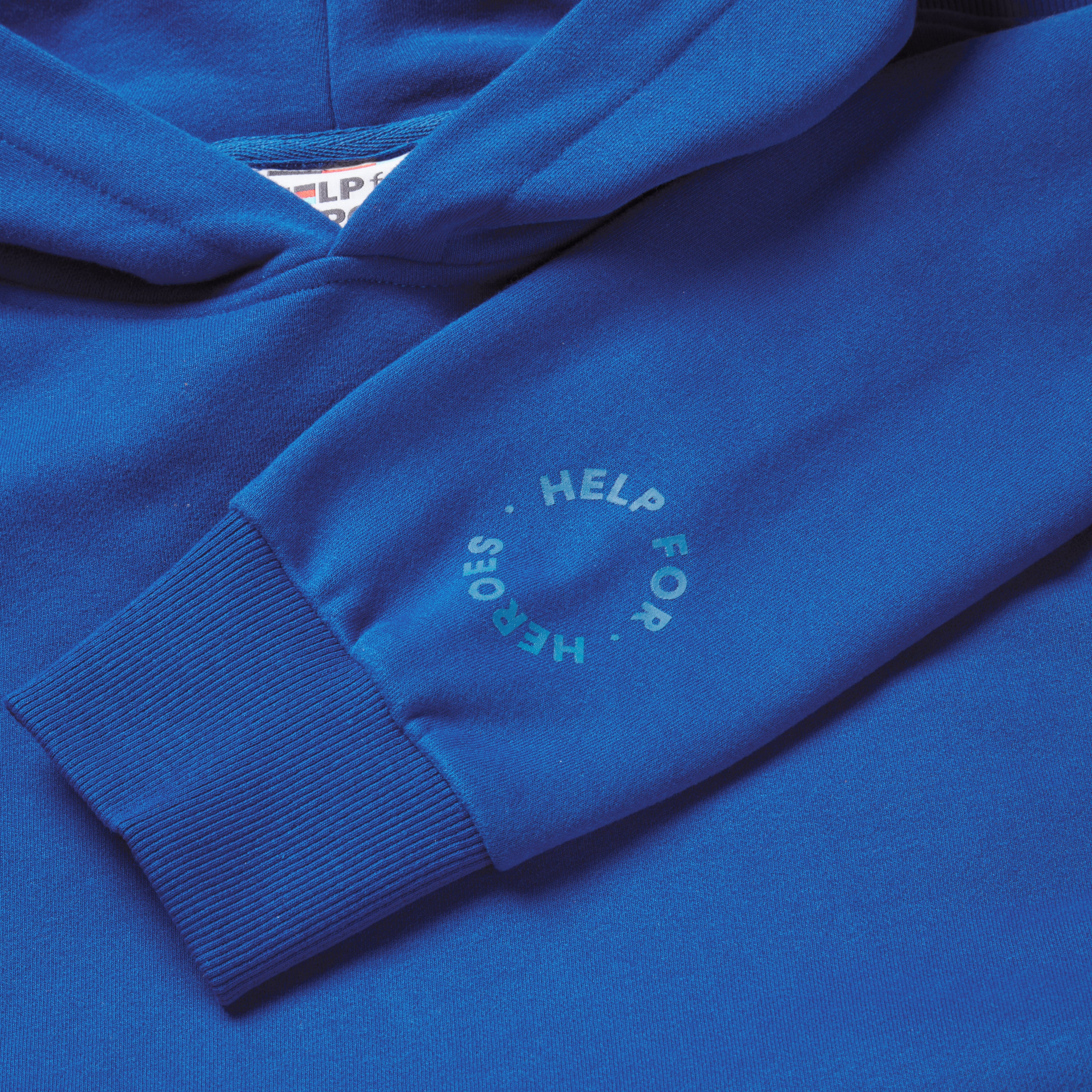 Close up image of a blue pullover hoodie with the text "redefine your path" and a mountain scene back print. Sleeve detail featuring a circular Help for Heroes logo