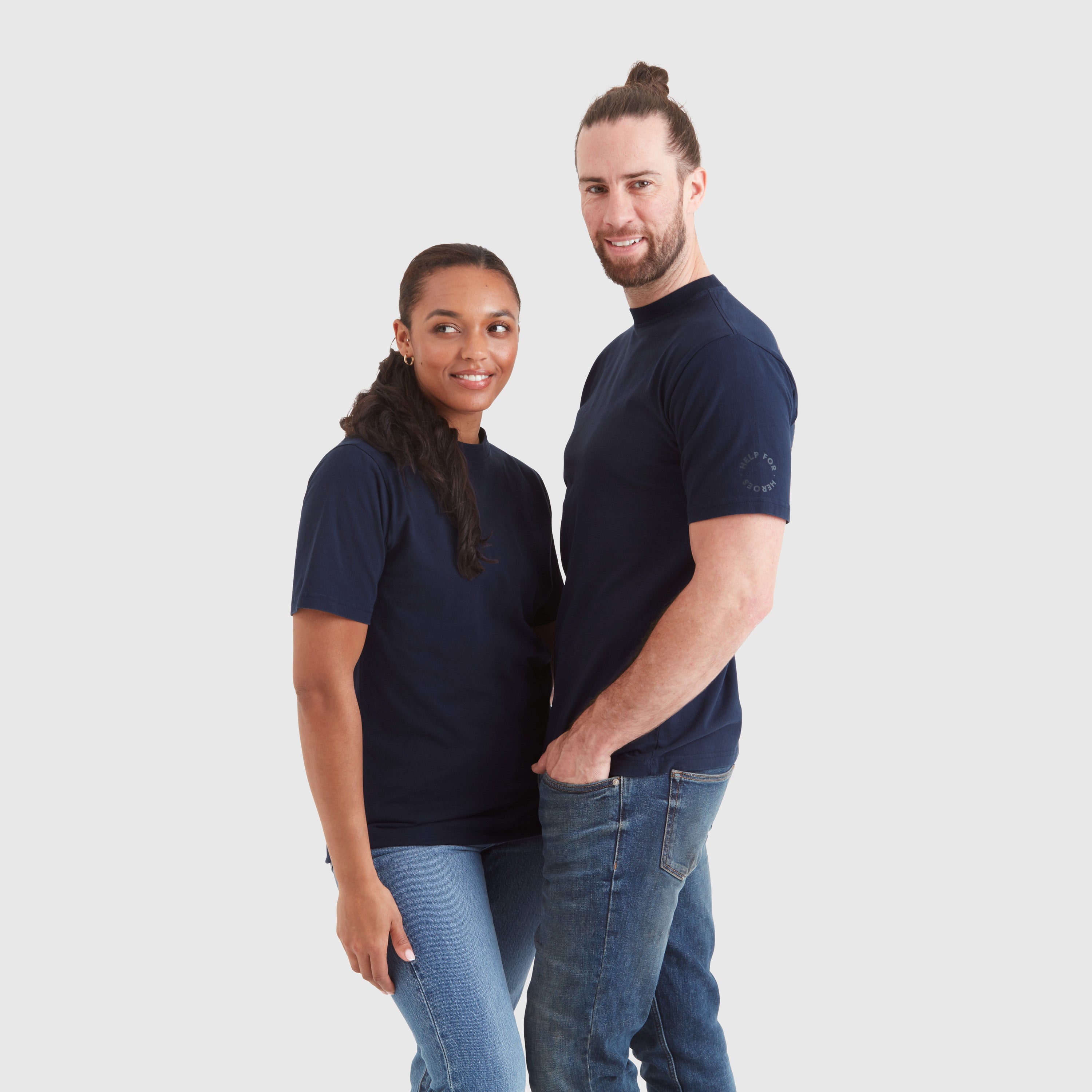 Models wearing a navy blue crew neck t-shirt with a "redefine your path" contrast slogan mountain back print in orange. Featuring a circular Help for Heroes logo on the sleeve