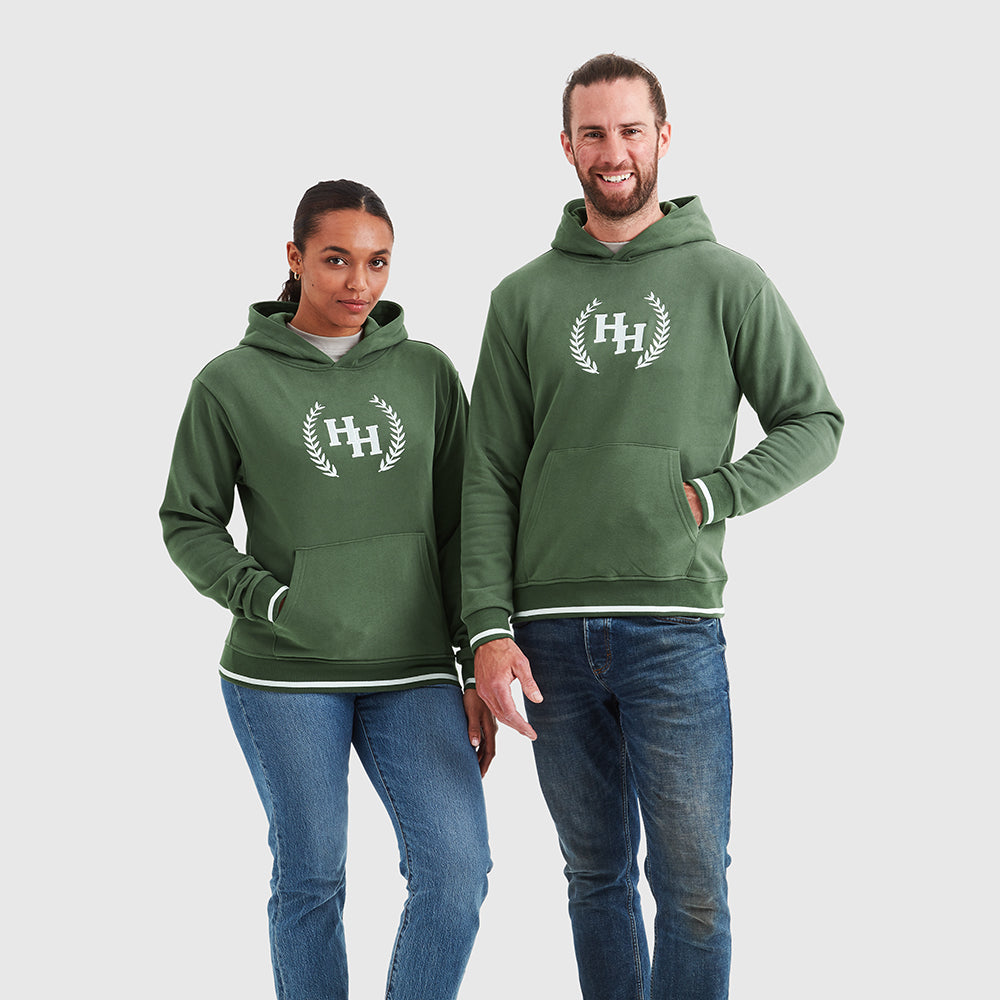 Two models wearing khaki green pullover hoodies with a Help for Heroes wreath logo design on the chest and tipped detailing to cuffs