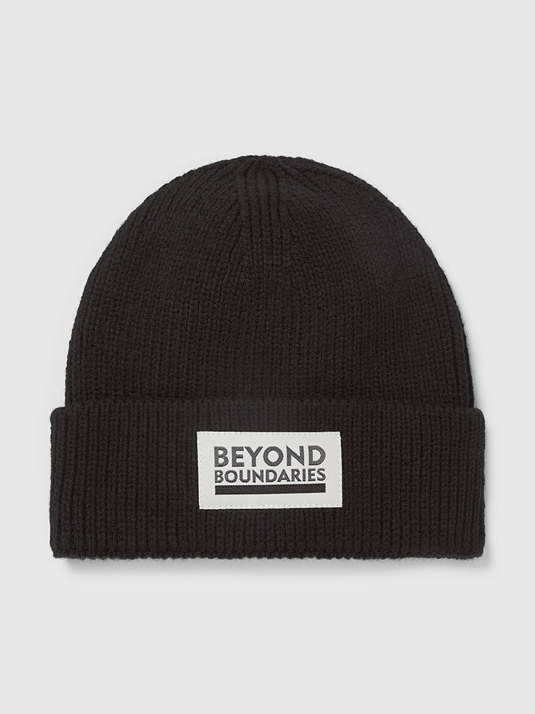 Front flat lay image of a Help for Heroes charcoal grey knitted beanie hat. Features sewn on patch with "Beyond Boundaries" text logo