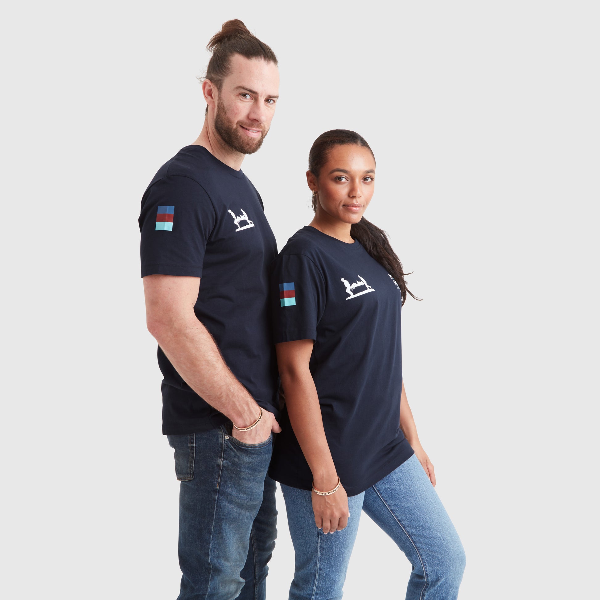 Two models wearing copper therapy bracelets featuring the Help for Heroes logo