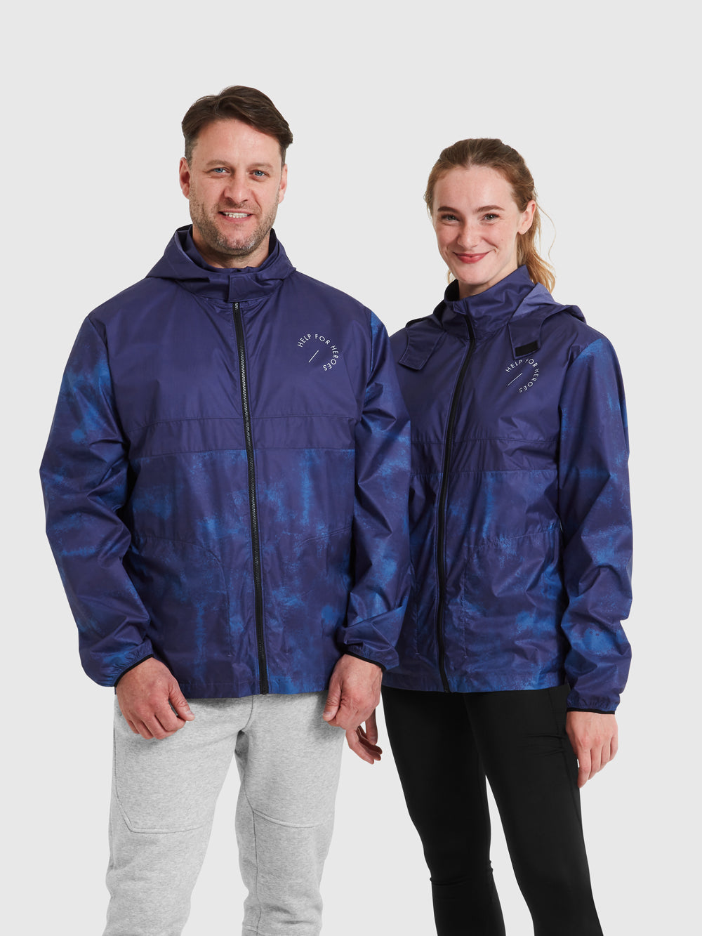 Models wearing blue cagoule sports jacket, featuring a hood and printed help for heroes logo on the chest