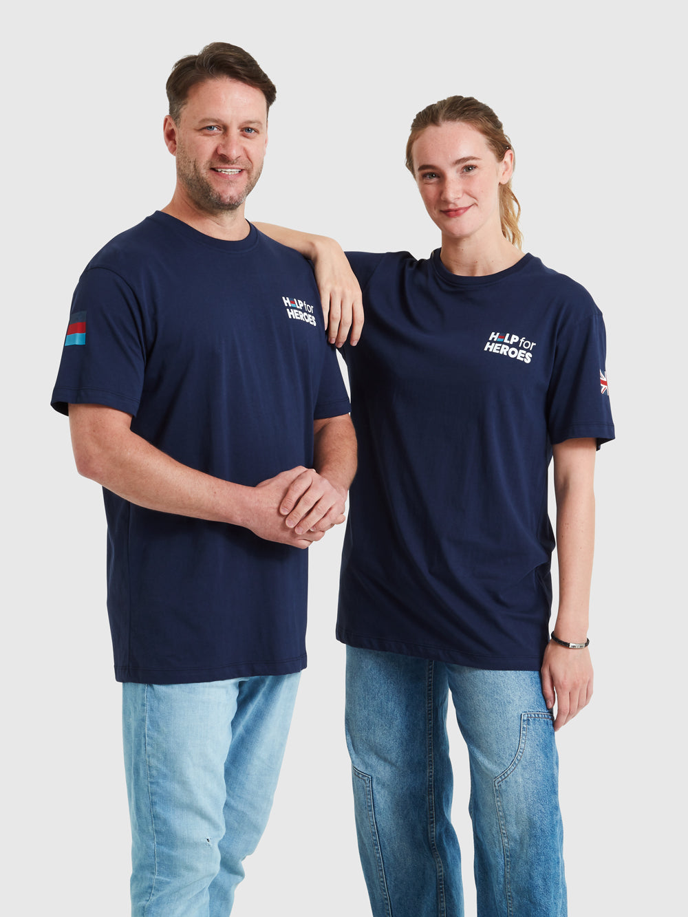 Two models wearing navy t-shirts, featuring the Help for Heroes logo, tri colour and union jack flags and stretcher bearer logo printed on the back