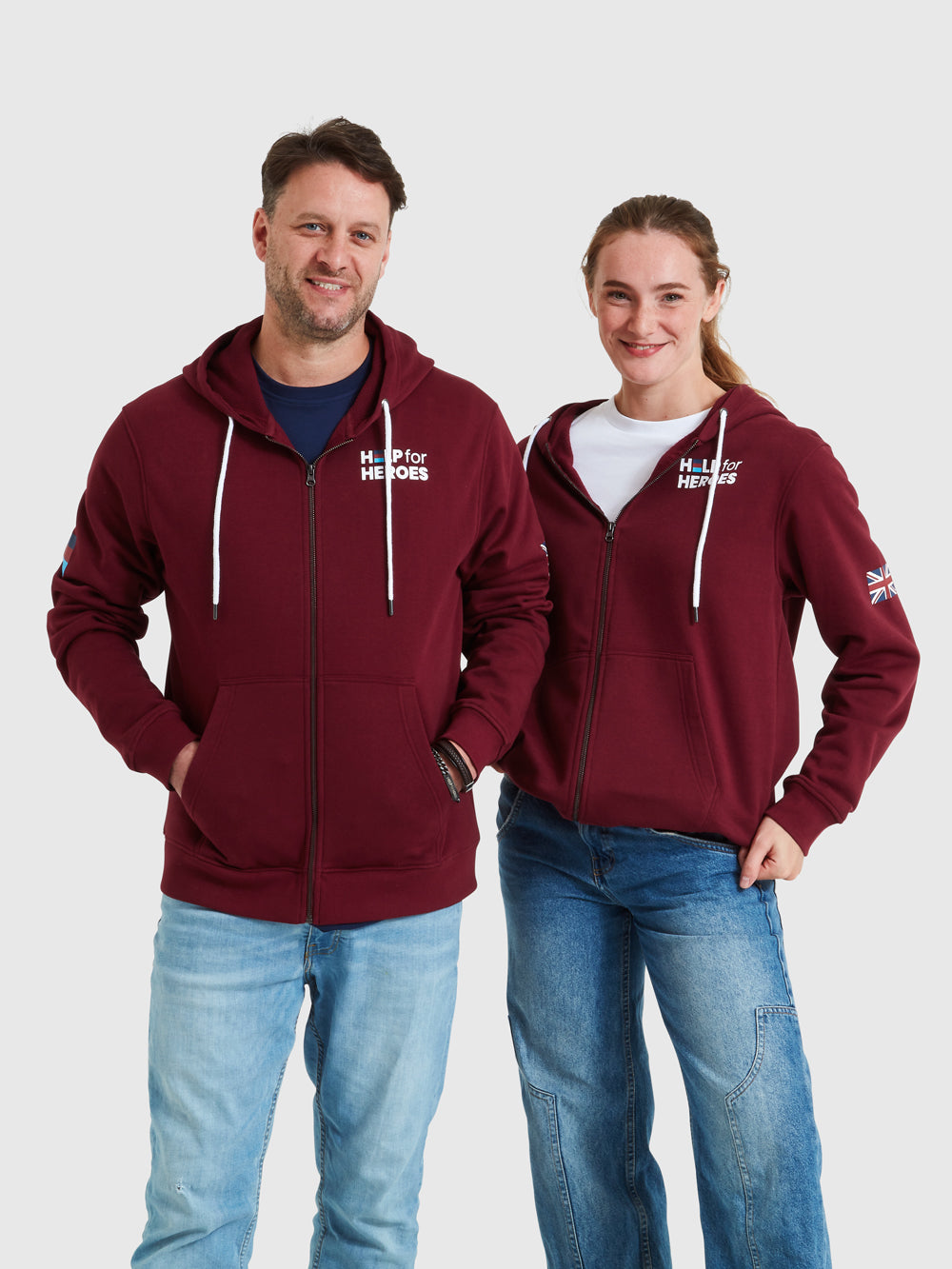 Models wearing burgundy zipped hoody featuring printed Help for Heroes logo on the front and Stretcher Bearer logo on the back. Union Jack printed on the sleeve