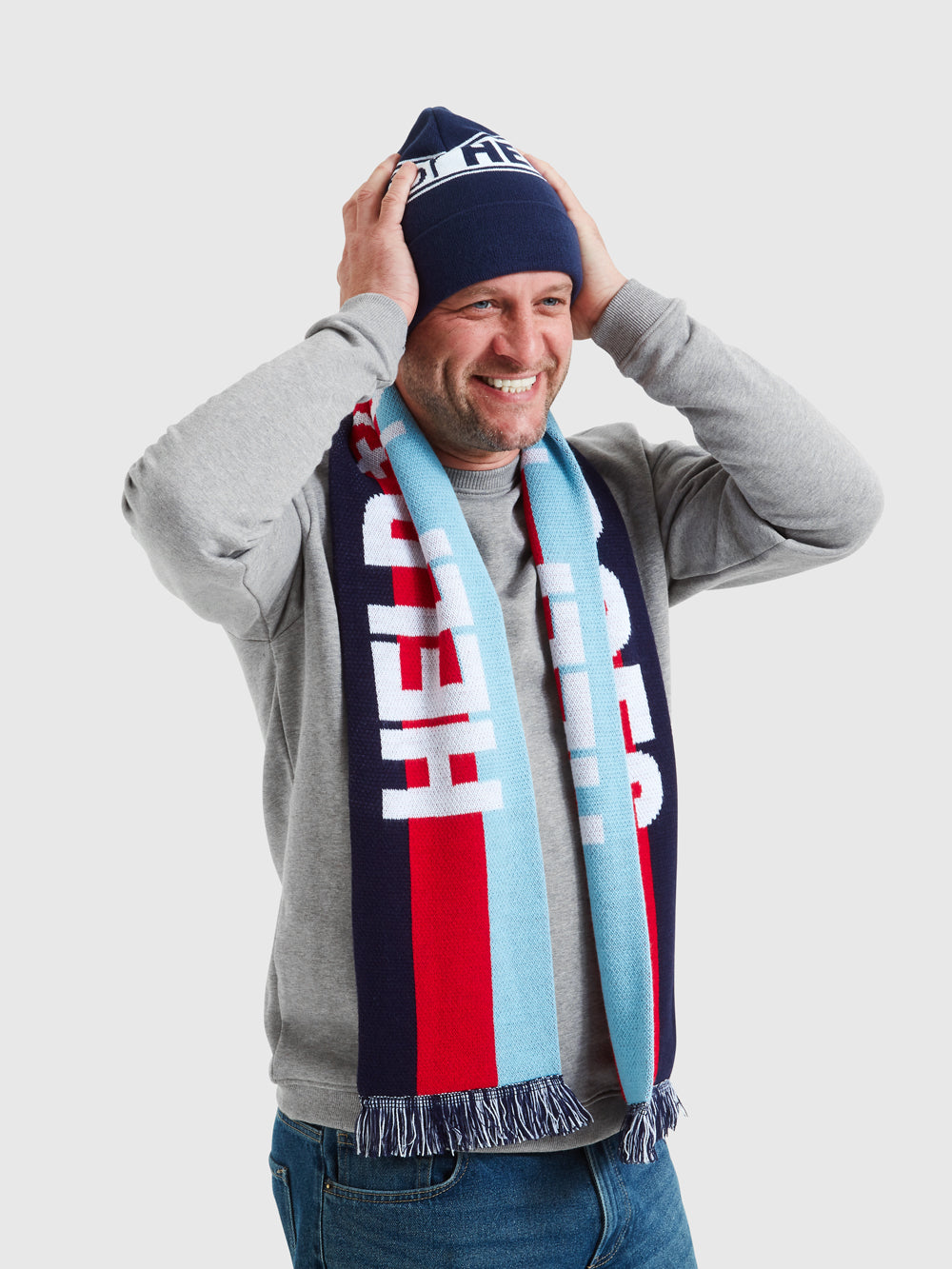Model wearing Navy beanie hat, featuring Help for Heroes and tri colour logo