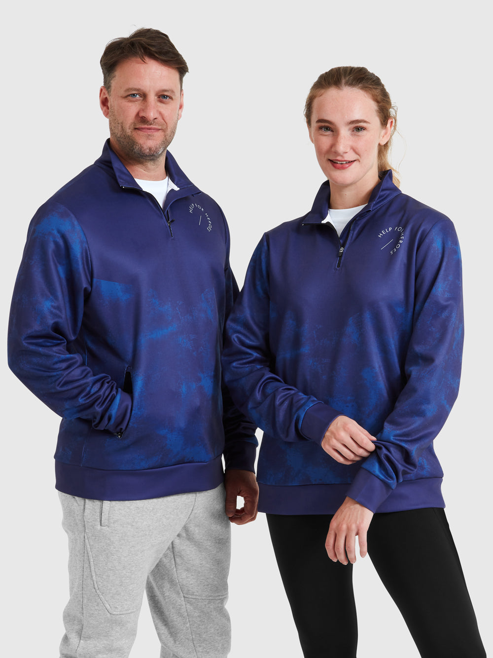 Models wearing mid layer blue sports top, featuring printed Help for Heroes logo