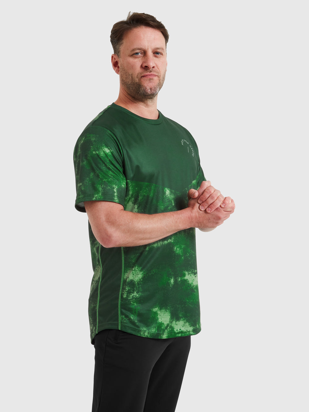 Model wearing forest green  Help for Heroes sports top, featuring printed logo on the chest