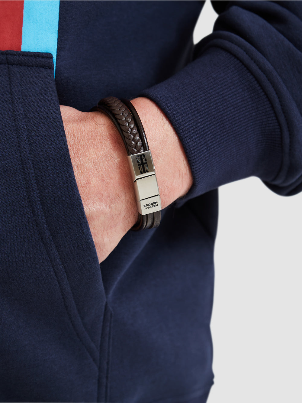 Help for heroes stacked brown leather bracelet. With a metal clasp featuring union jack and logo, worn on model's wrist