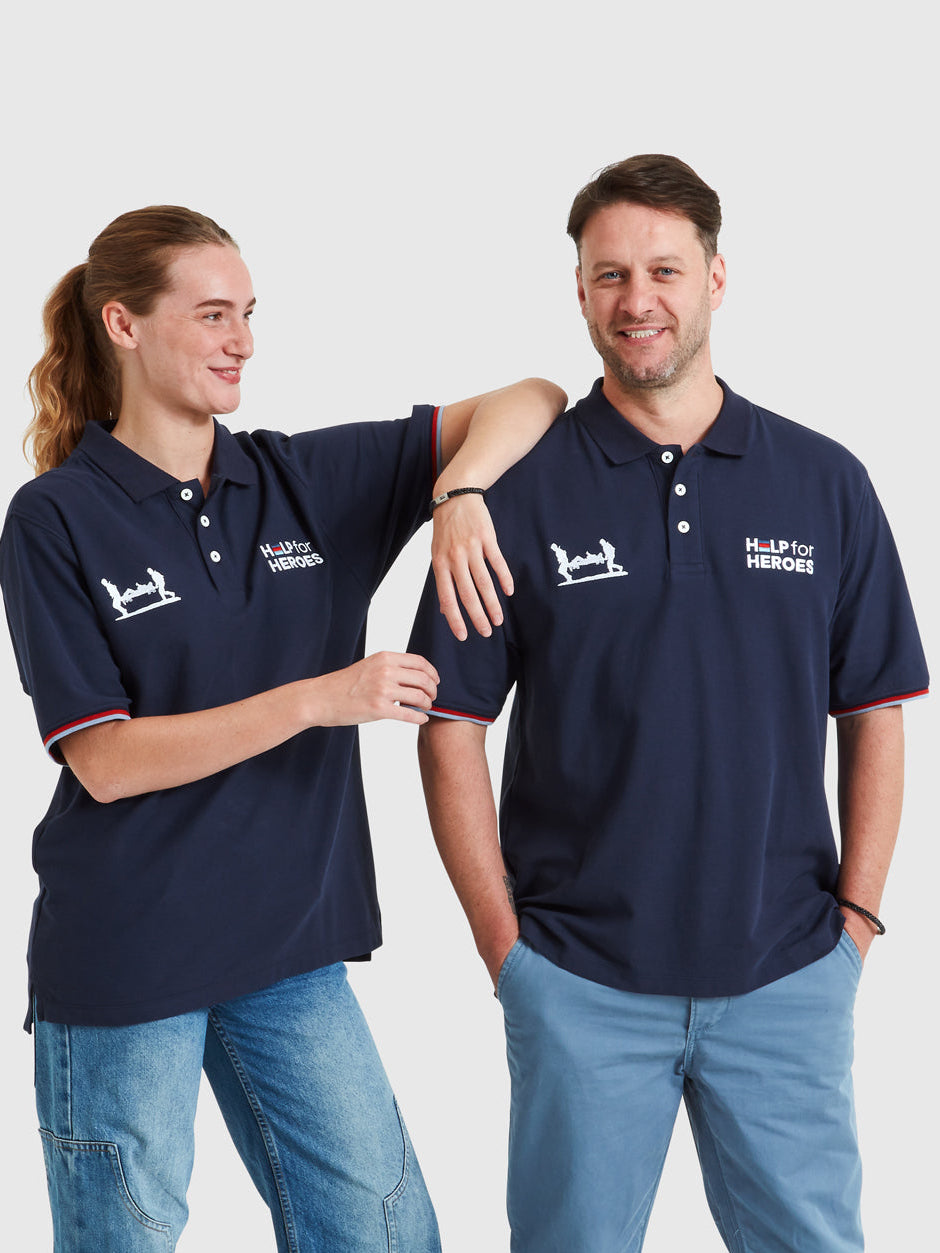 Two models wearing navy polo shirts which feature Help for Heroes logo, Stretcher Bearer logo and tri colour tipped sleeves