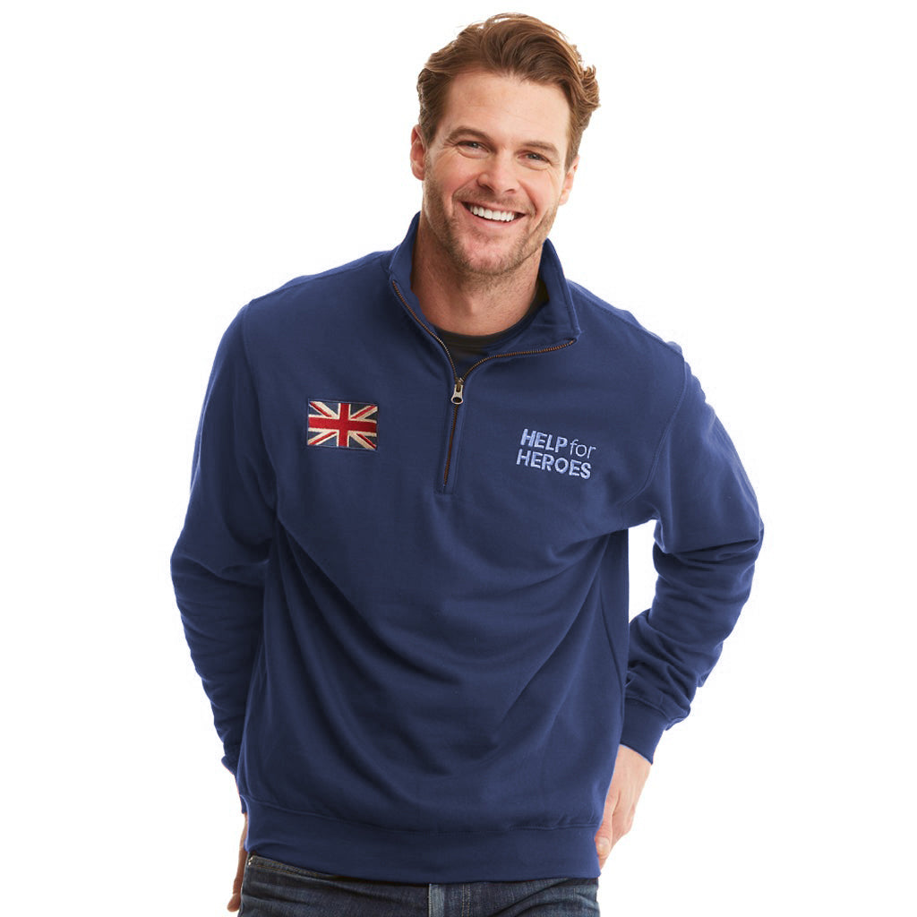 Model wearing navy quarter zip sweatshirt with printed union jack flag and Help for Heroes logo