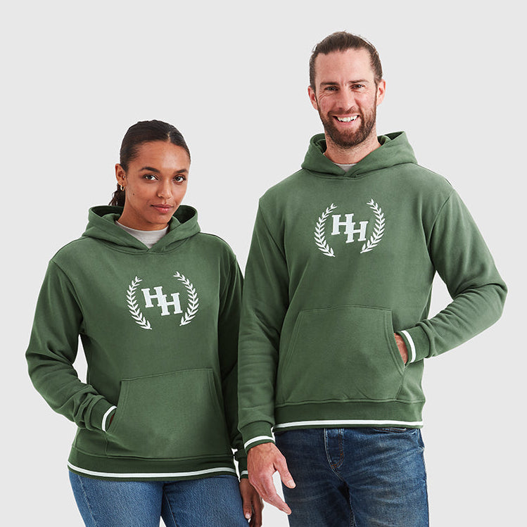Two models wearing khaki green pullover hoodies with a Help for Heroes wreath logo design on the chest and tipped detailing to cuffs